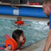 A young girl enjoys a Be Well Learn to Swim session