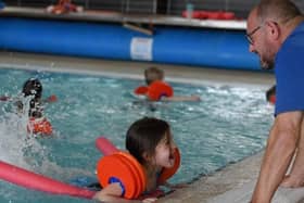 A young girl enjoys a Be Well Learn to Swim session