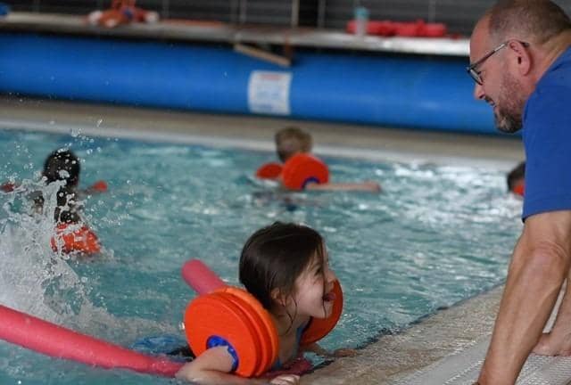 A young girl enjoys a Be Well Learn to Swim session