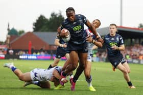 Wigan Warriors forward Junior Nsemba in action with Wakefield Trinity's Corey Hall