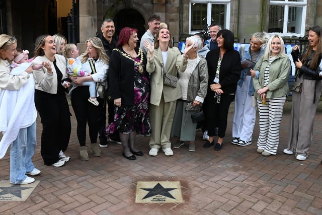Football champion Ella Toone, Lioness and European Championship Winner, pictured with family and friends at a ceremony to present her Wigan Council star, placed outside Leigh Town Hall.