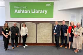 Council officers and councillors gather around the tablets at Ashton Library.