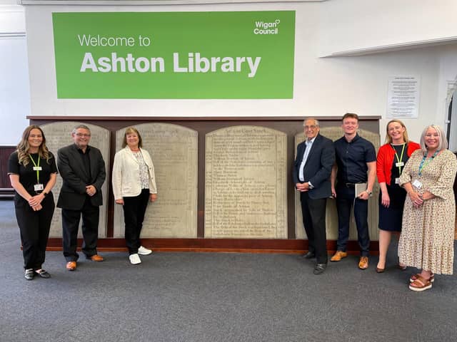 Council officers and councillors gather around the tablets at Ashton Library.