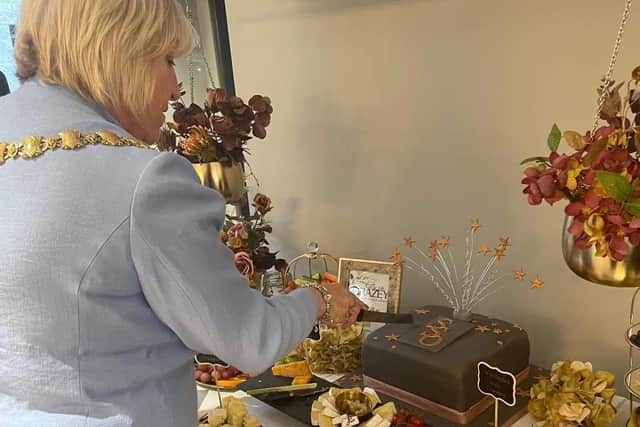 The Mayor cuts a celebratory cake at Standish Styling Optician's official opening