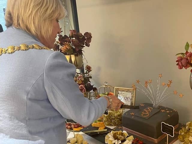 The Mayor cuts a celebratory cake at Standish Styling Optician's official opening