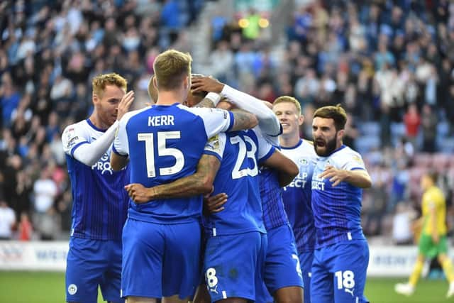 Josh Magennis is mobbed after his opening goal