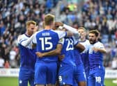 Josh Magennis is mobbed after his opening goal