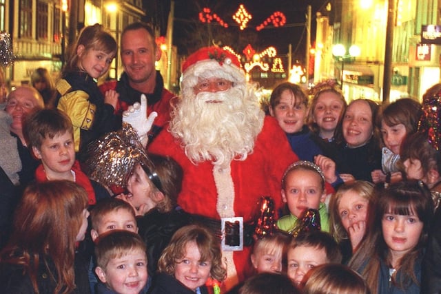 1999 Santa surrounded by excited youngsters after switching on the Christmas lights. Picture Frank Orrell.