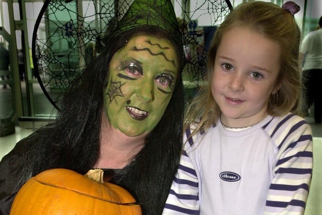 Wigan Asda staff donned Halloween costumes to entertain children and hand out free sweets. Pictured is Sarah Willmoth the friendly witch with young customer Hannah Barker