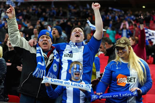 Wigan Athletic fans enjoy the atmosphere during the FA Cup with Budweiser Semi Final match between Millwall and Wigan Athletic at Wembley Stadium on April 13, 2013