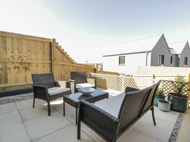 The enclosed patio is super for alfresco dinners overlooking glorious countryside at The Waves.