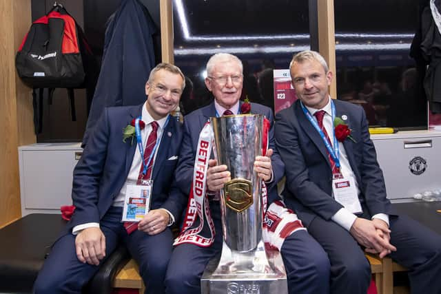 Outgoing Wigan chairman Ian Lenagan with sons Adrian & Simon and the Betfred Super League trophy