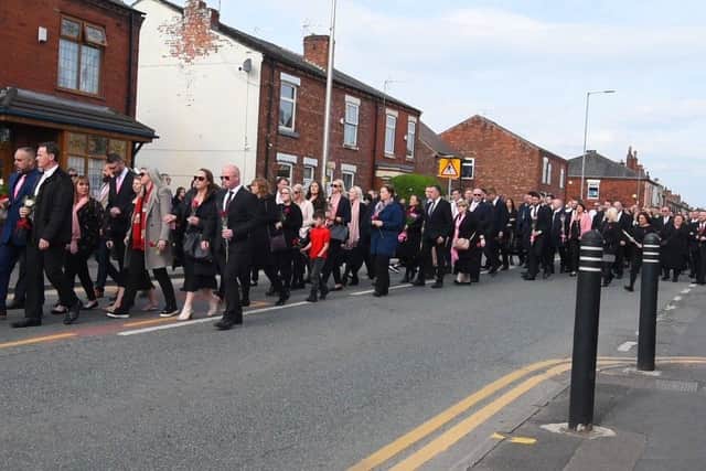 Hundreds of people attended the funeral, with many carrying a single red or pink rose for Holly