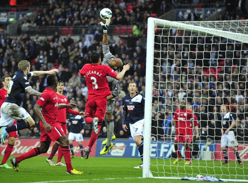 Wigan Athletic's Omani goalkeeper Ali Al Habsi (C) stretches to reach the ball clear