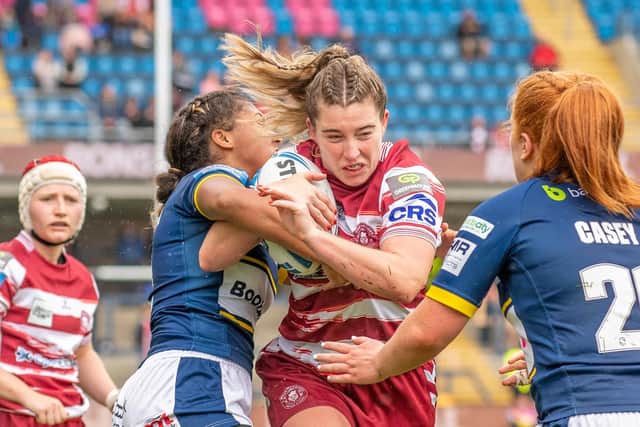 Wigan’s Victoria Molyneux is tackled by Leeds’ Sophie Robinson