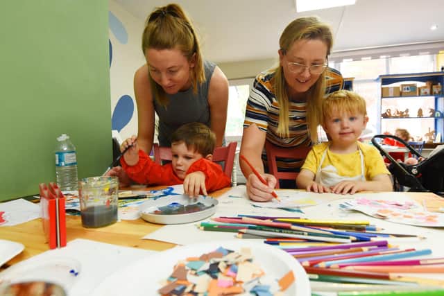 From left, Rebecca Parkinson and Freddie, two, and Hayley Farrell with Cody, two, have fun creating at the Little Shop of Creativity