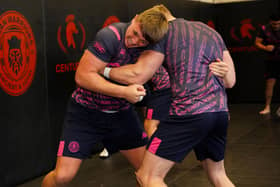 Harvie Hill and Zach Eckersley wrestle in the gym at Robin Park Arena