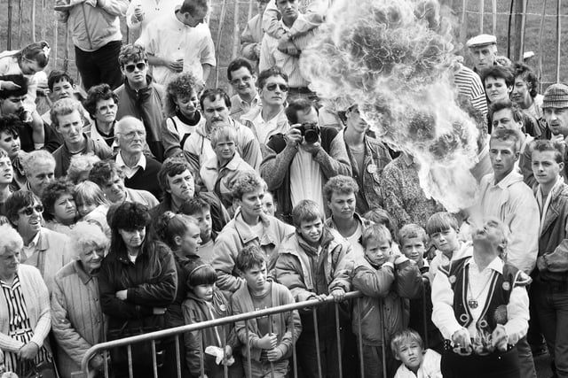 A fire-eater wows the crowds at Haigh Carnival on Bank Holiday Monday 29th of August 1988.