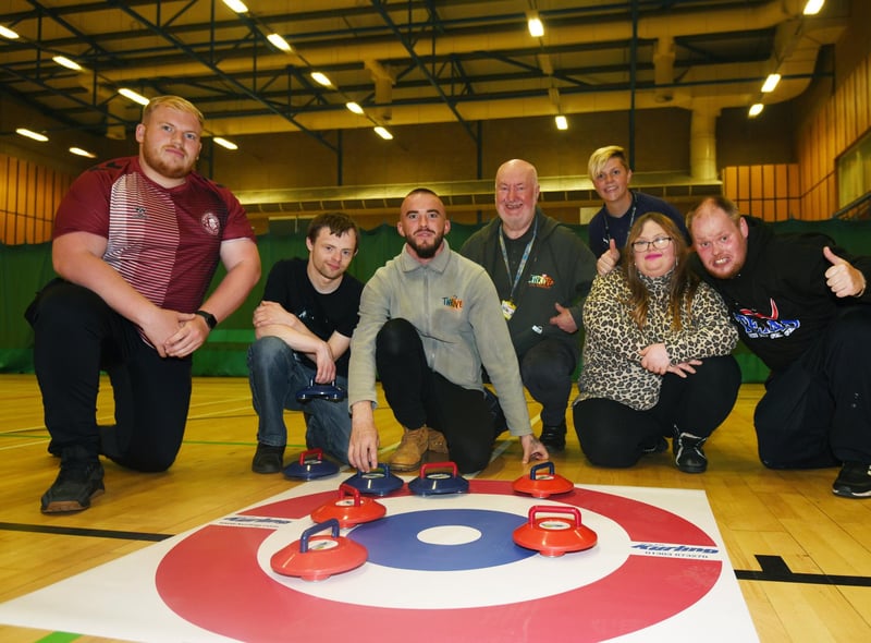 Members from Thrive CIC try curling