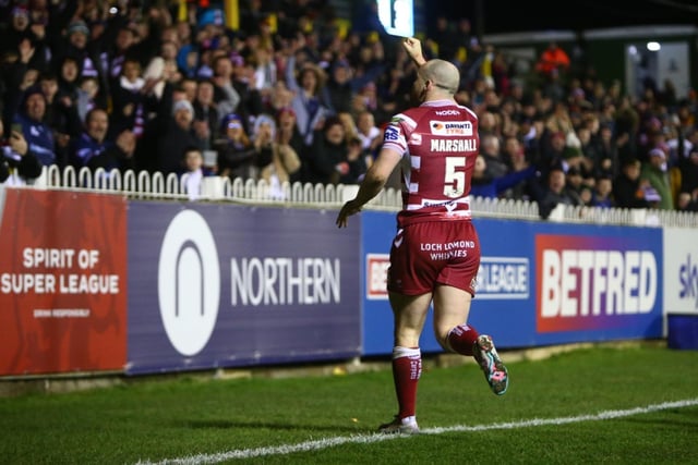 Wigan Warriors fans celebrate Marshall's hat-trick try.