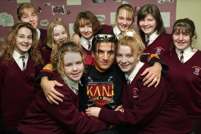 Pop star Peter Andre hugs St. Thomas More RC High School pupils Adele Dean and Bernadine Hidden surrounded by other pupils after performing several of his songs on stage at the Newtown school including his new single 'The Only One' on Thursday 15th of February 1996. Adele and Bernadine had heard that Peter was touring Britain and nominated their school as a venue and were overwhelmed when he agreed to a show.