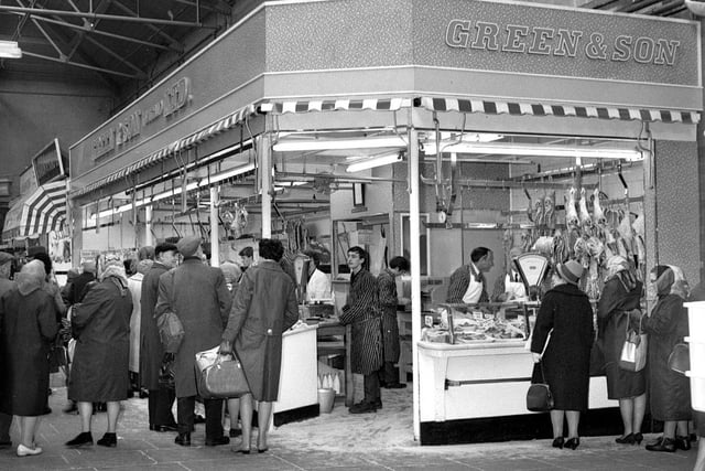 The busy Green & Son butchers stall in the old Wigan Market Hall in 1966.