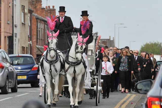 A horse-drawn carriage led the procession to the church