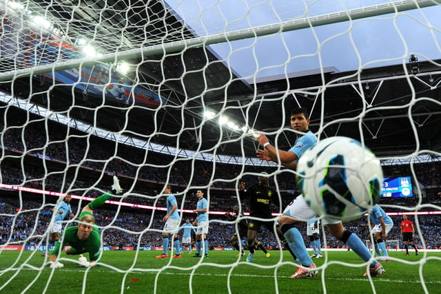 Goalkeeper Joe Hart and Sergio Aguero of Manchester City look on in vain as the header from Ben Watson of Wigan Athletic hits the back of the net for the match winning goal during the FA Cup with Budweiser Final between Manchester City and Wigan Athletic at Wembley Stadium on May 11, 2013 in London, England.