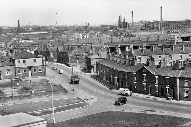 A view looking towards Wigan town centre along Ormskirk Road, Newtown, in the late 1960s.  In the middle is Middleton & Wood Funeral Directors premises. The building across the road is the Bird i'th Hand pub on Douglas Street with Soho Street and then Robin Park Road running parallel.