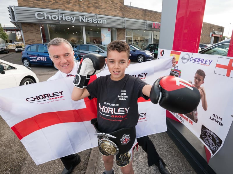 Thai boxing champion Sam Lewis, nine, from Westhoughton, with Gary Lamb, sales manager of Chorley Nissan, Wigan, who had sponsored his travel to compete for the European title in Spain