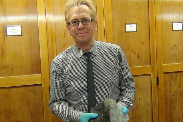 Wigan writer Russell Parry with a piece of the Appley Bridge meteorite at the Natural History Museum in London