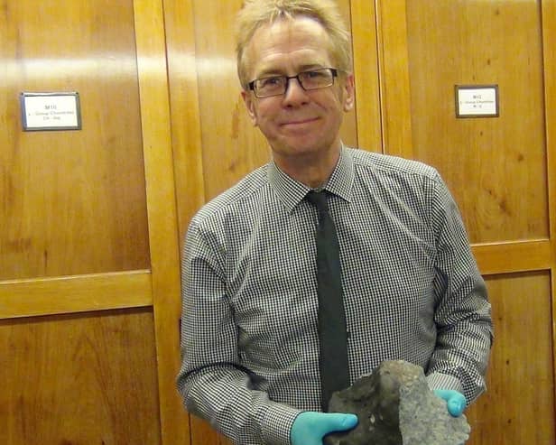Wigan writer Russell Parry with a piece of the Appley Bridge meteorite at the Natural History Museum in London
