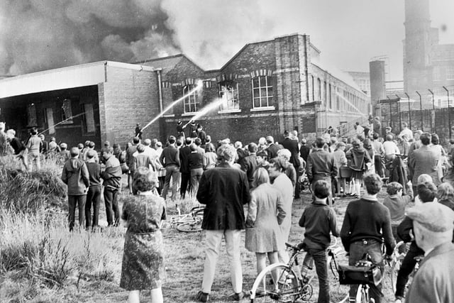 Crowds gather to watch firemen battle the huge fire at John England's Gidlow Mills factory near Mesnes Park on Monday 20th of October 1969. 