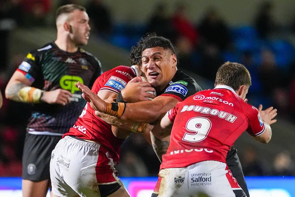 Wigan’s Patrick Mago is tackled by Salford's Amir Bourouh