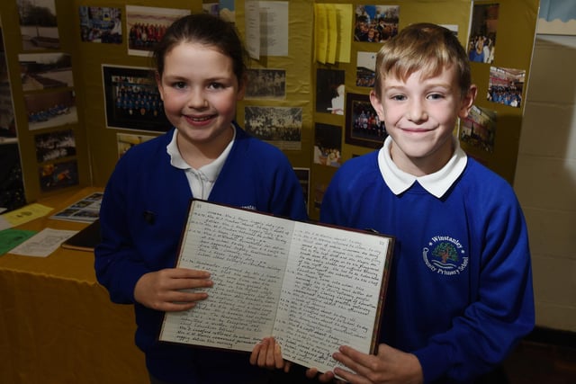 Pupils with a log book that dates back to 1972.
