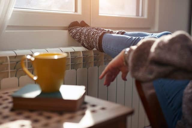 A woman heating her feet on a chilly winter day