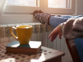A woman heating her feet on a chilly winter day