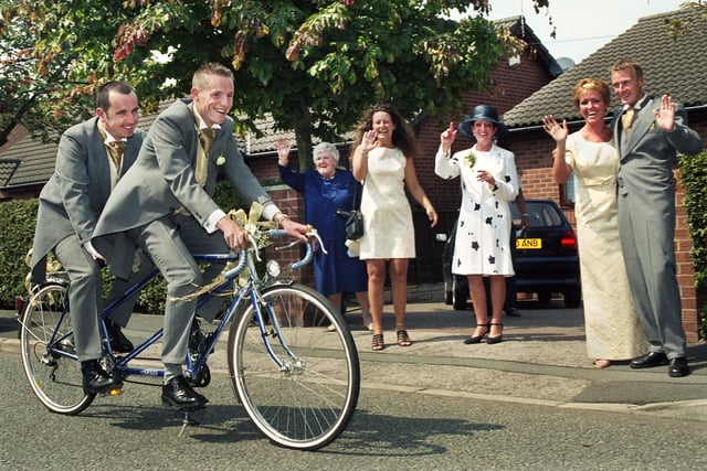 On a bicycle made for two are groom, Stephen Stoneman, aged 29, and best man Andrew Doyle setting off from Leyland Green Road, Downall Green, for Stephen's wedding to teacher Helen Cheshire at St. Oswald's RC Church, Ashton, on Saturday 31st of July 1999.
The tandem trip was the idea of professional cyclist Stephen whose only worry was of getting his tails caught in the wheels.