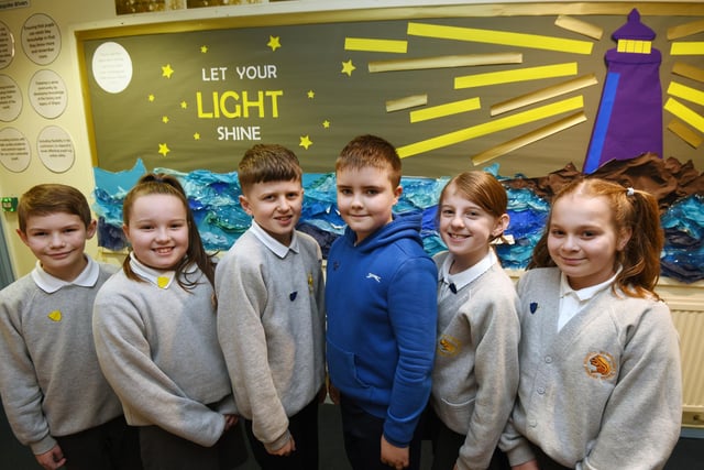 Members of the pupil Leadership team in front of the 'let your light SHINE' display.