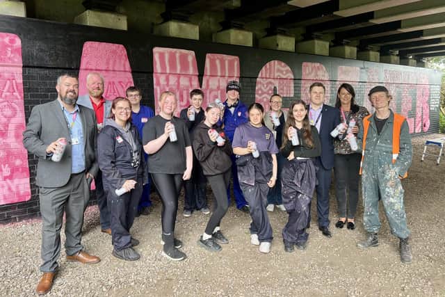 I Am Greater mural with Leigh Youth Hub, Oskar with a K and Wigan Council representatives