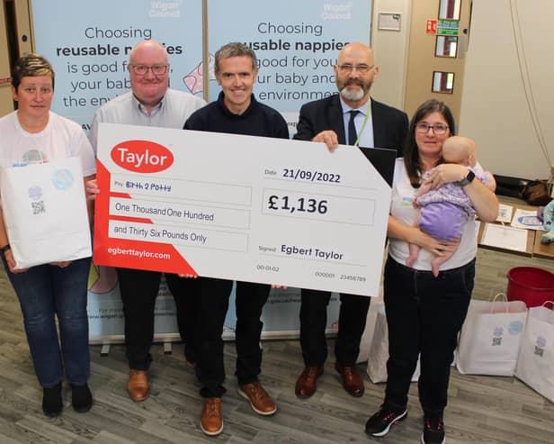 Taylor’s Kevin Docherty (second from left) presents Wigan Council’s Louise Atherton, Peter Davies and Coun Paul Prescott, and Birth 2 Potty’s Lisa Woodger (far right), with a cheque for £1,136 at a reusable nappy event at Armed Forces HQ in Wigan