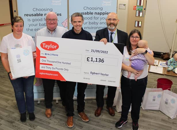 Taylor’s Kevin Docherty (second from left) presents Wigan Council’s Louise Atherton, Peter Davies and Coun Paul Prescott, and Birth 2 Potty’s Lisa Woodger (far right), with a cheque for £1,136 at a reusable nappy event at Armed Forces HQ in Wigan