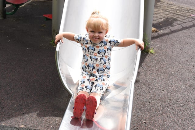 Daisy McSorley, two, has fun in the sun, playing in the park at Three Sister, Ashton-in-Makerfield.