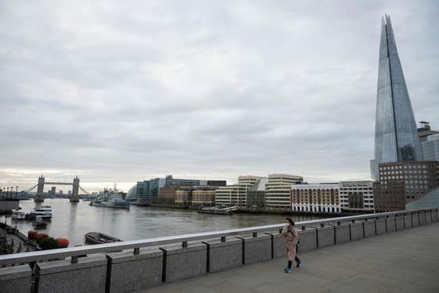 A woman crosses London Bridge during what would usually be the busy pre-9am rush-hour (Photo: Leon Neal/Getty Images)
