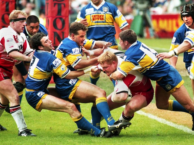 Neil Cowie takes some stopping near the Leeds try line.