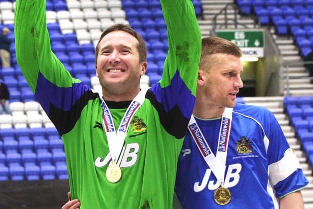 John Filan and Matt Jackson celebrate as Wigan Athletic lift the Division 2 championship trophy after beating Barnsley 1-0 with a Tony Dinning goal  on Saturday 3rd of May, the last day of the 2002/2003 season. 