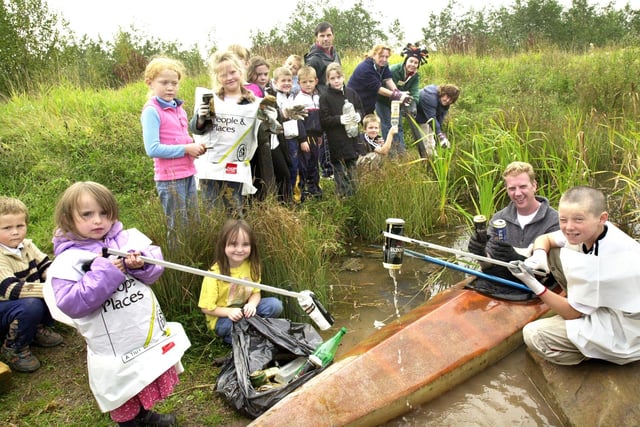 People and Places Manager, Nick Burdekin, with helpers and local youngsters cleaning up Angel pond in Marsh Green on Saturday 11th of October 2003.