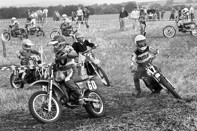 A junior motocross race in fields off Meadow Pit Lane, Haigh, organised by the Newton-le-Willows club on Sunday 2nd of September 1984.