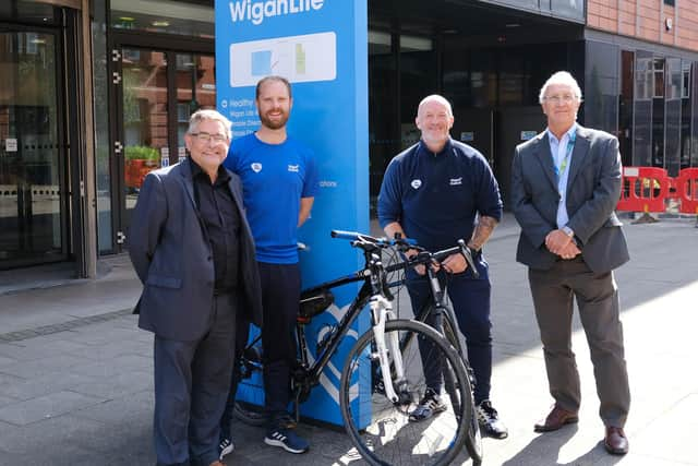 Welcoming the Tour of Britain to Wigan are councillors Chris Ready, left and David Molyneux, right, with Richard Smith and Andrew Hakesley, from Be Well