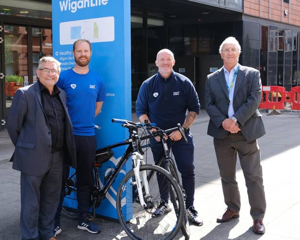 Welcoming the Tour of Britain to Wigan are councillors Chris Ready, left and David Molyneux, right, with Richard Smith and Andrew Hakesley, from Be Well